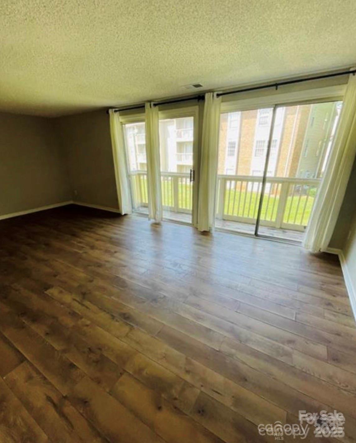 1624 Arlyn Circle, Unit G Charlotte, NC 28213 - Photo 3 of 13 a view of an empty room with a window