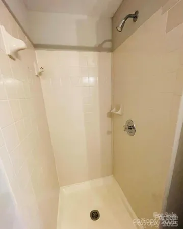 a bathroom with a granite countertop sink and a toilet