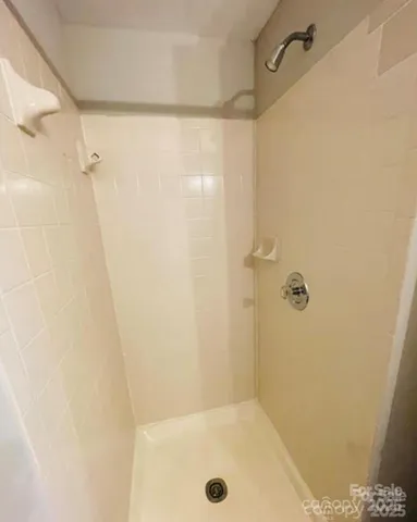 a bathroom with a granite countertop sink and a toilet