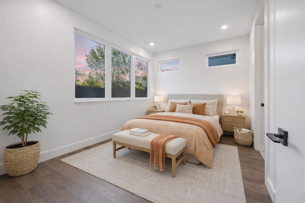 4101 Menchaca Road, Unit 102 Austin, TX 78704 - Photo 9 of 14 Well-lit sleeping quarters with rich hardwood flooring and a broad window showcasing verdant outdoor scenery.