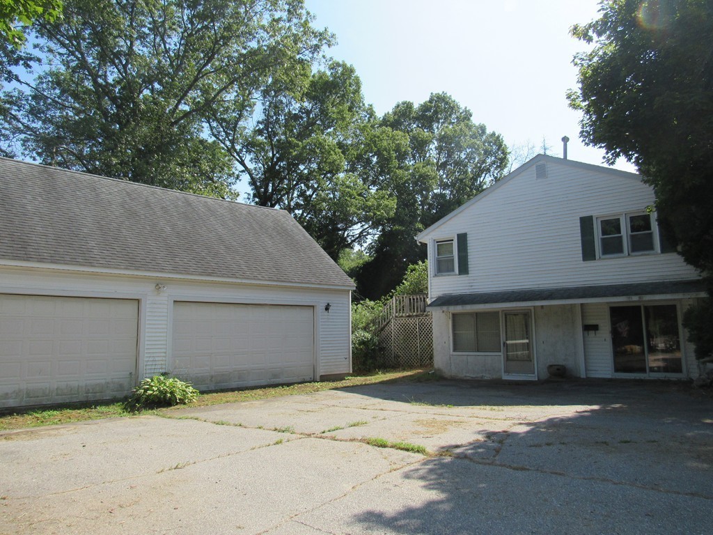 5 Capt Peter Simpson Road Millbury, MA 01527 - Photo 2 of 35 a front view of a house with a yard and garage