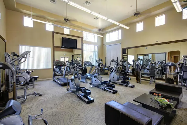a room with gym equipment and a large window
