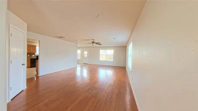 a view of a room with wooden floor and windows