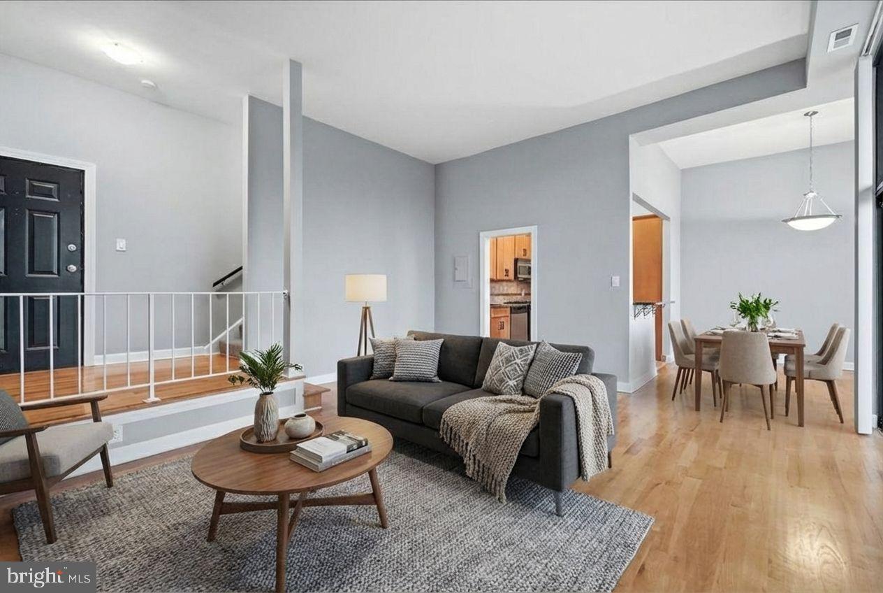 10860-10864 Bucknell Drive, Unit 301 Silver Spring, MD 20902 - Photo 3 of 24 a living room with furniture and wooden floor