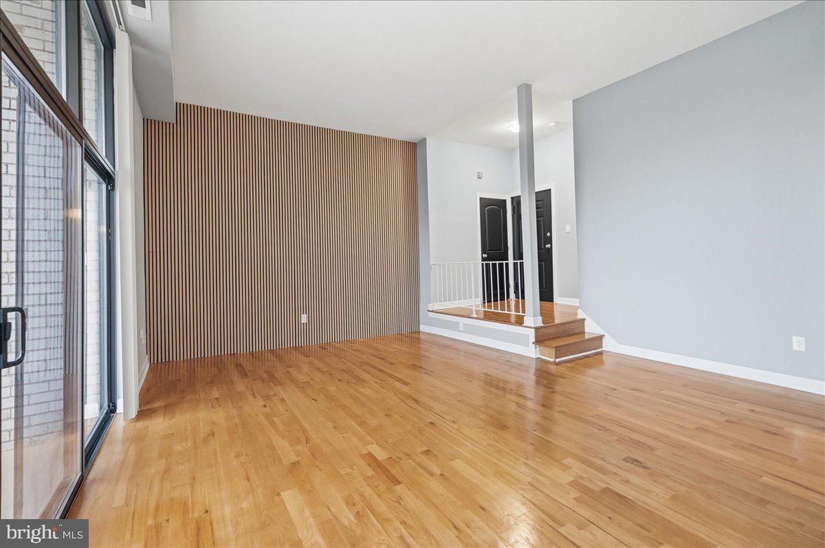 10860-10864 Bucknell Drive, Unit 301 Silver Spring, MD 20902 - Photo 10 of 24 a view of an empty room with wooden floor and a window