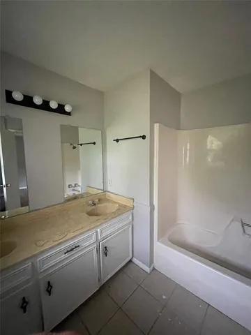 a bathroom with a granite countertop sink a toilet and shower