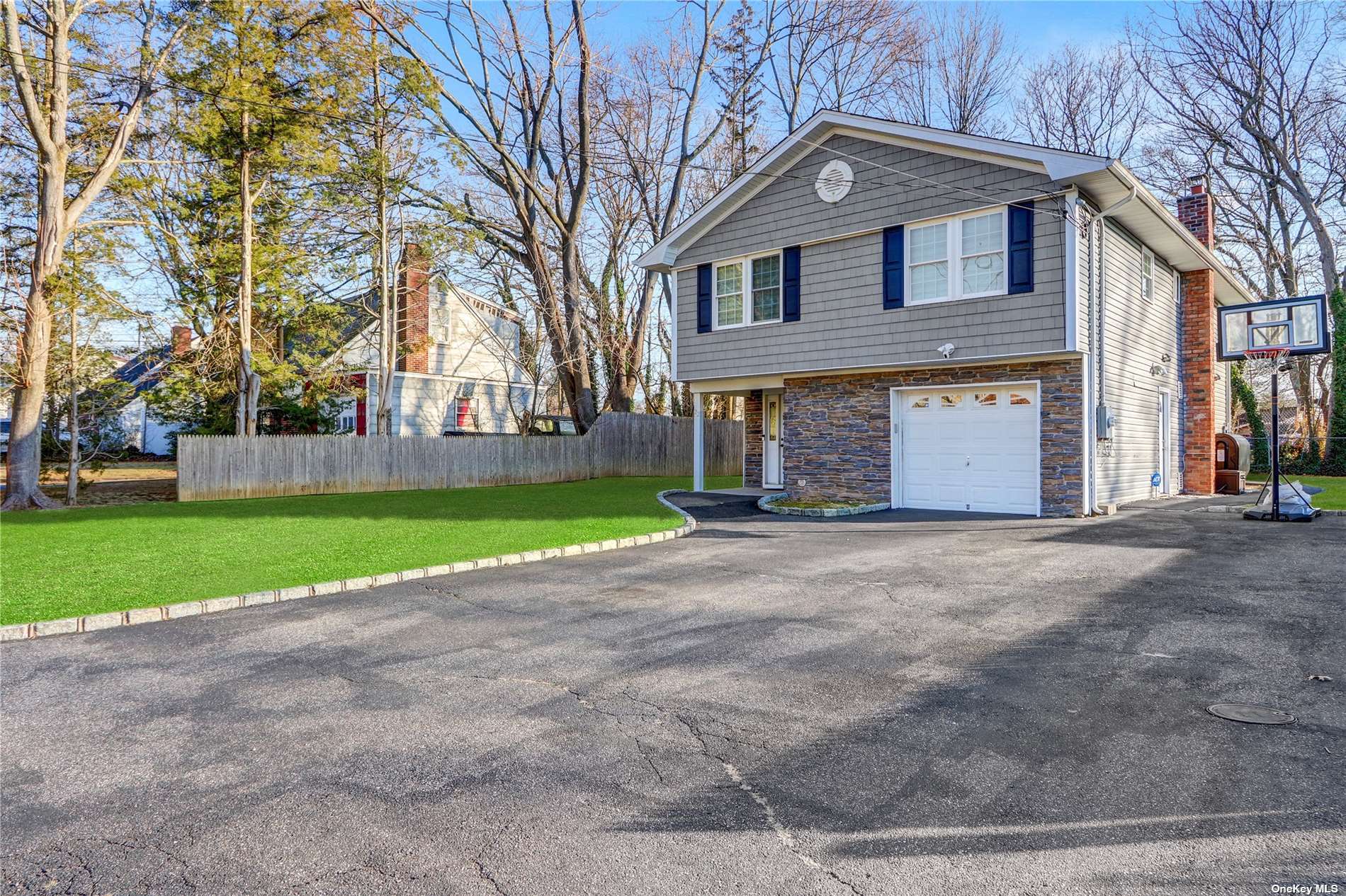 22 Yorktown Road Dix Hills, NY 11746 - Photo 1 of 1 a front view of a house with a yard and garage