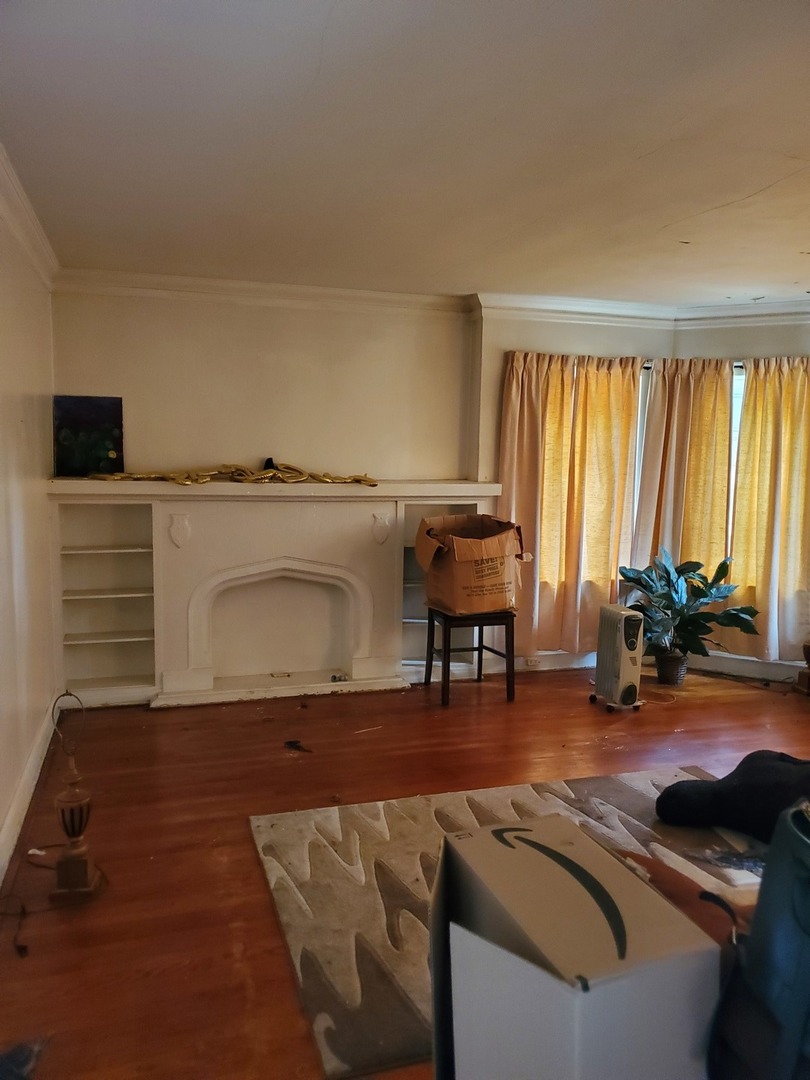 8238 South Rhodes Avenue Chicago, IL 60619 - Photo 2 of 5 a living room with furniture and a floor to ceiling window
