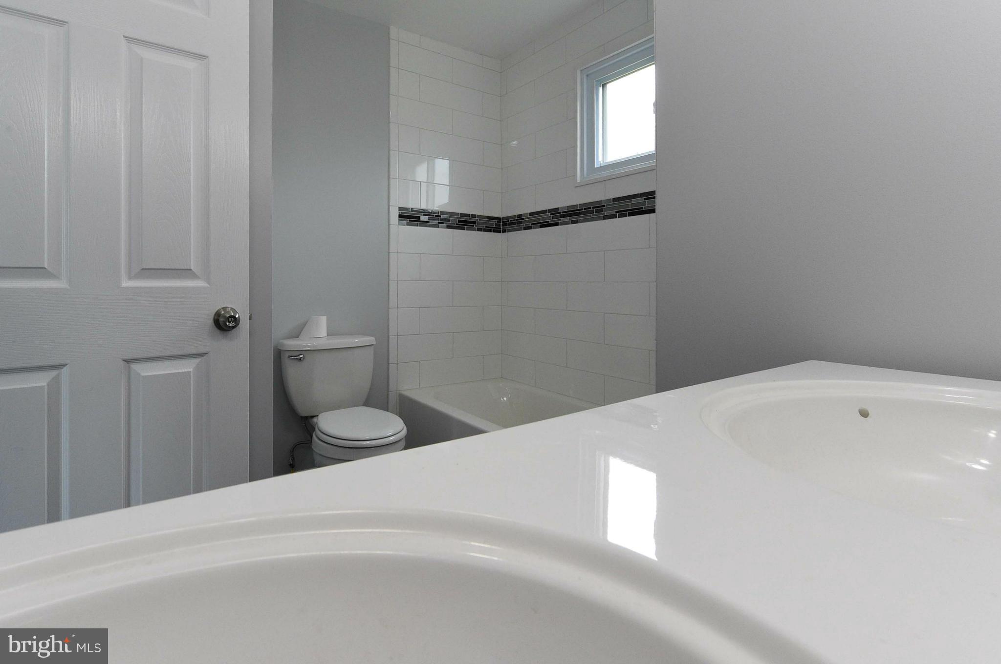 3822 Byfield Road Baltimore, MD 21207 - Photo 14 of 30 a bathroom with a sink and a toilet