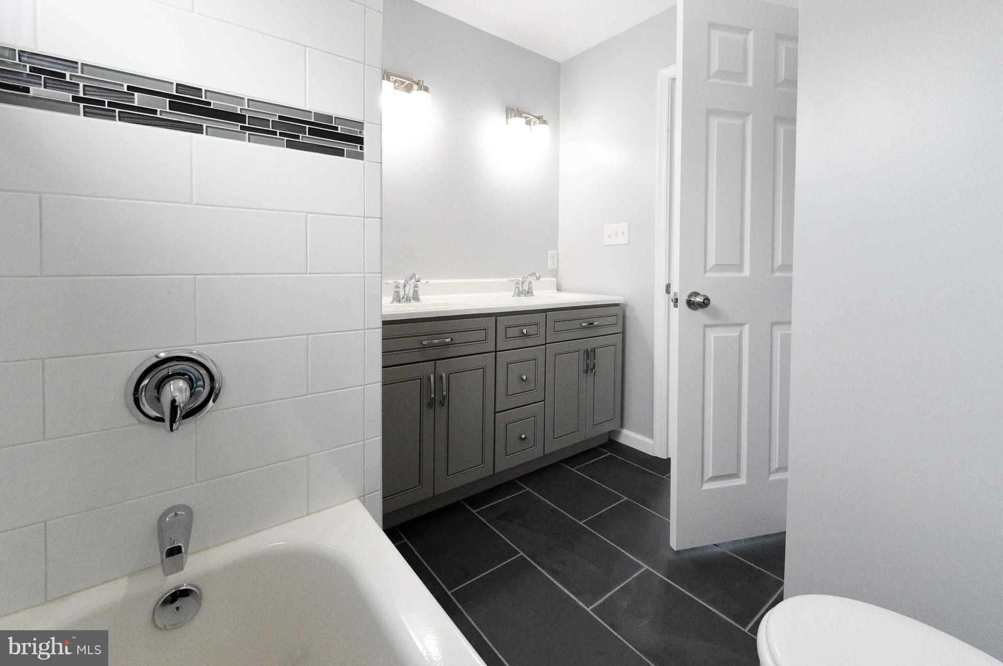 3822 Byfield Road Baltimore, MD 21207 - Photo 15 of 30 a bathroom with a sink a toilet and shower