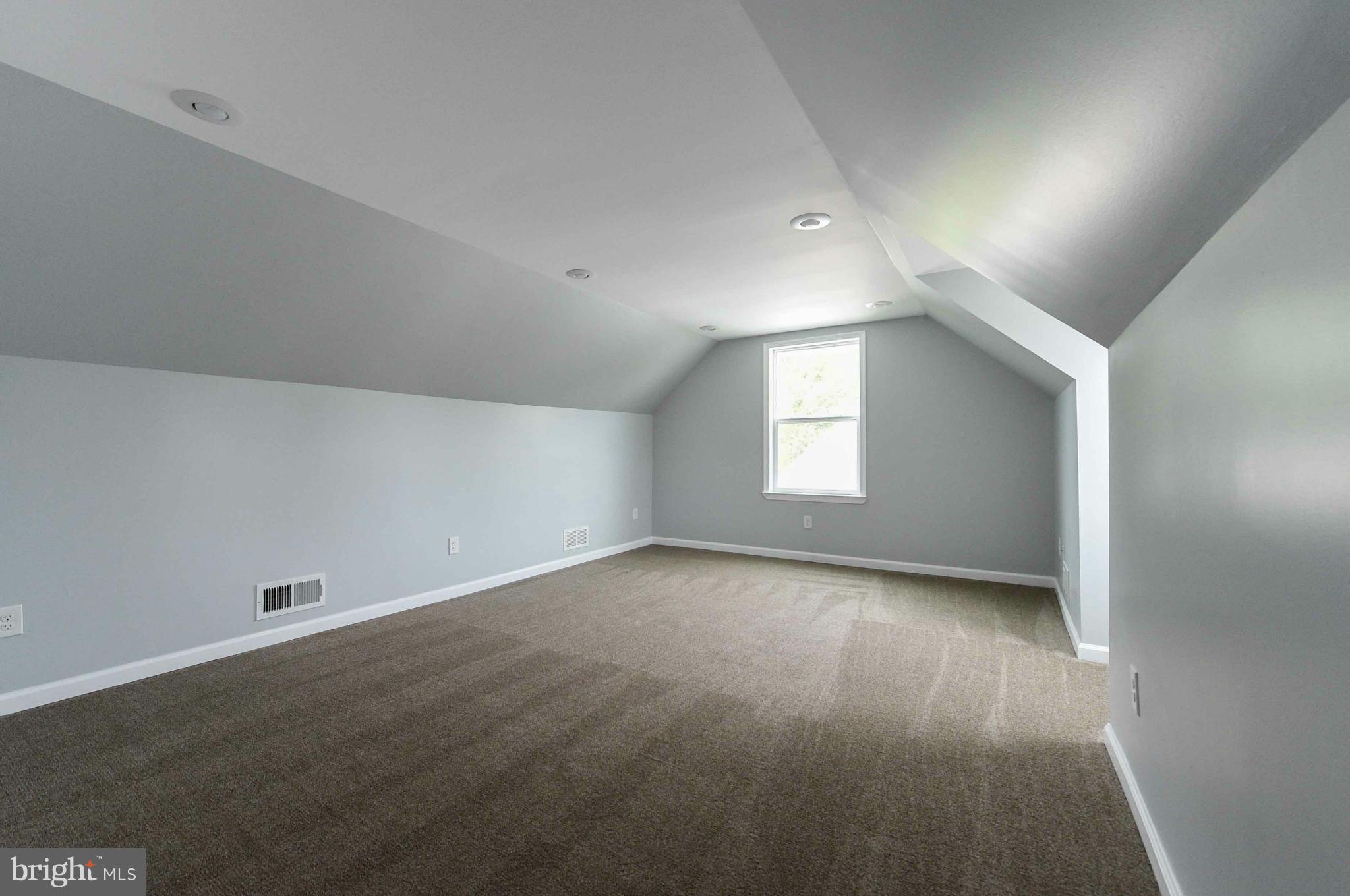 3822 Byfield Road Baltimore, MD 21207 - Photo 19 of 30 an empty room with wooden floor and windows