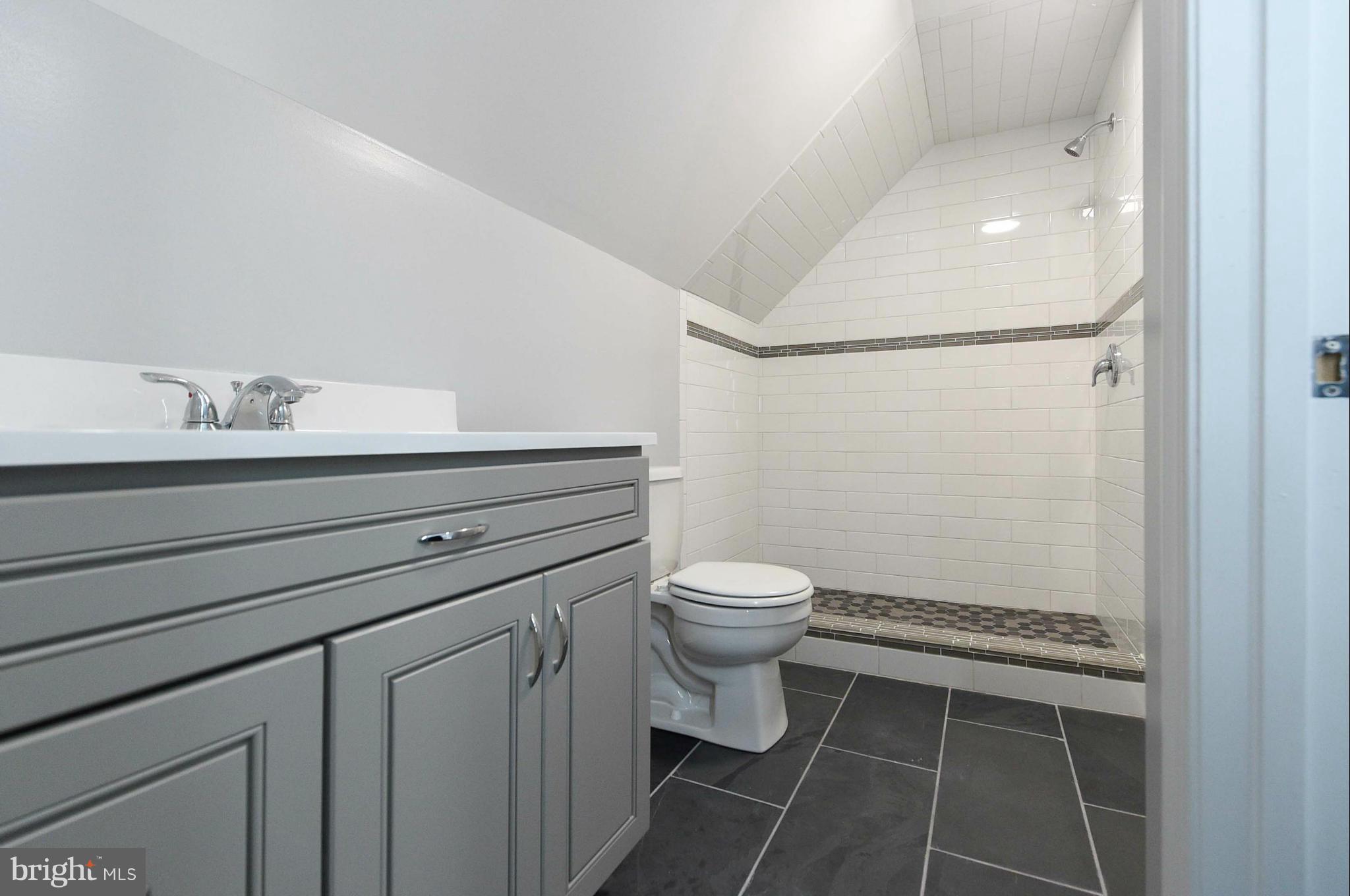 3822 Byfield Road Baltimore, MD 21207 - Photo 20 of 30 a bathroom with a granite countertop toilet sink and mirror