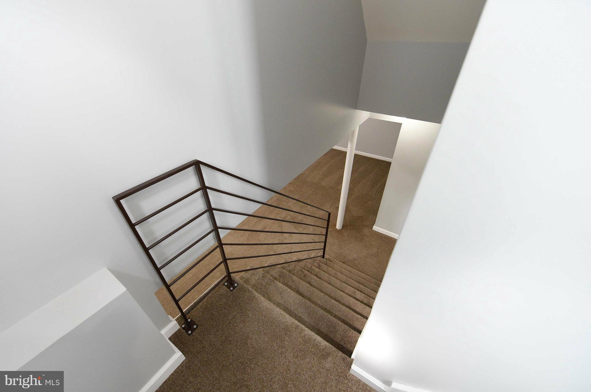 3822 Byfield Road Baltimore, MD 21207 - Photo 21 of 30 a view of entryway with stairs and wooden floor