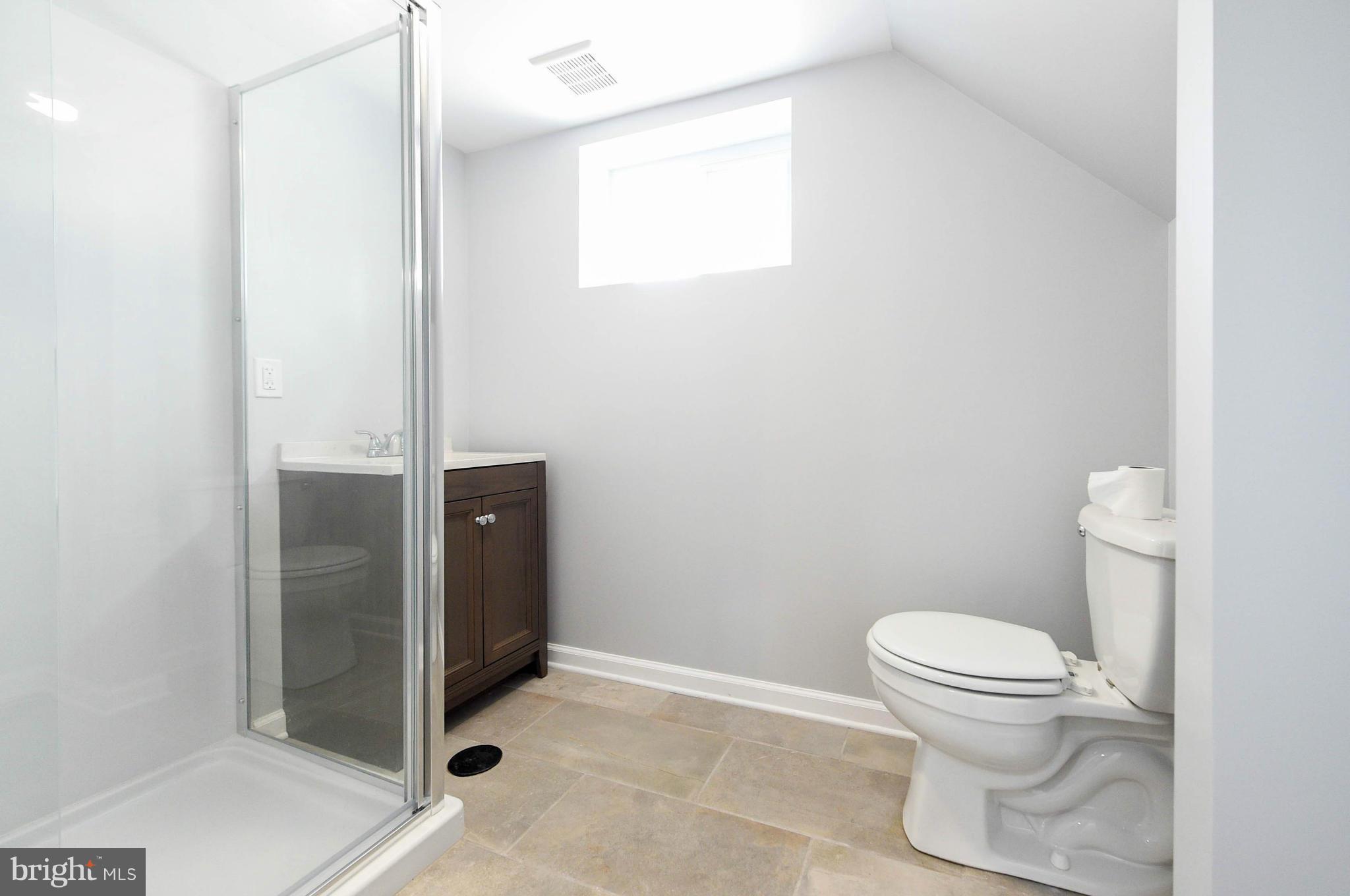 3822 Byfield Road Baltimore, MD 21207 - Photo 25 of 30 a bathroom with a toilet and a shower