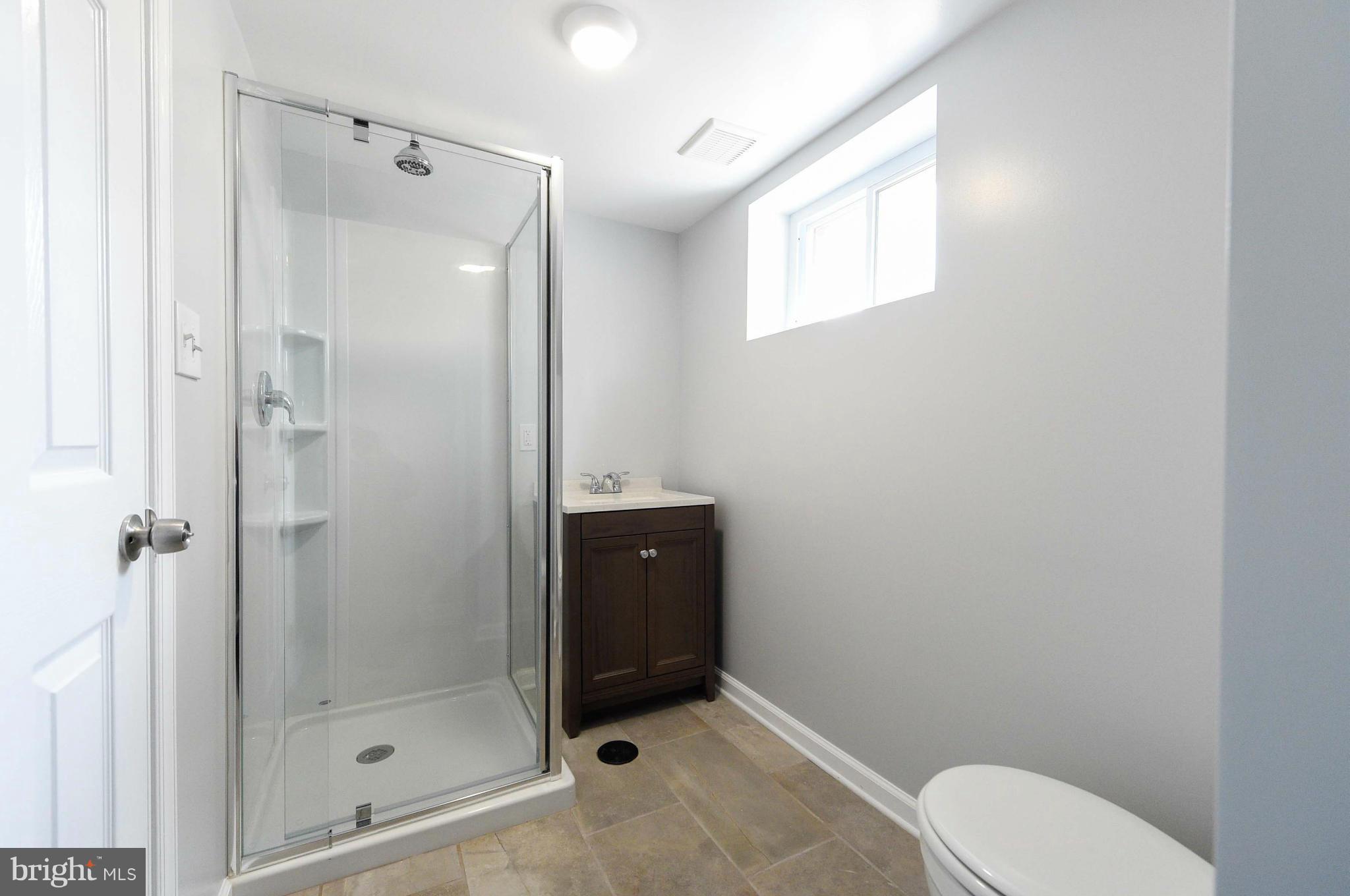 3822 Byfield Road Baltimore, MD 21207 - Photo 26 of 30 a bathroom with a toilet a sink and shower