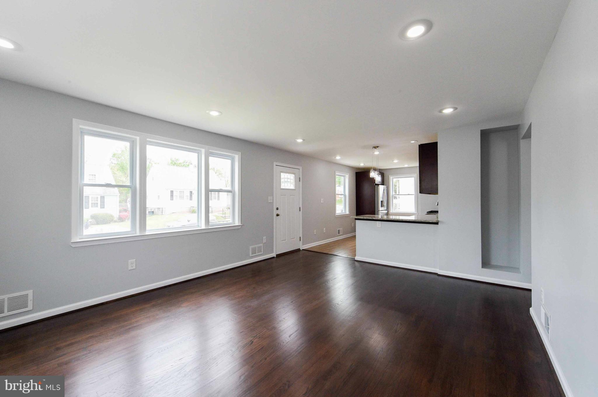3822 Byfield Road Baltimore, MD 21207 - Photo 5 of 30 an empty room with wooden floor and windows