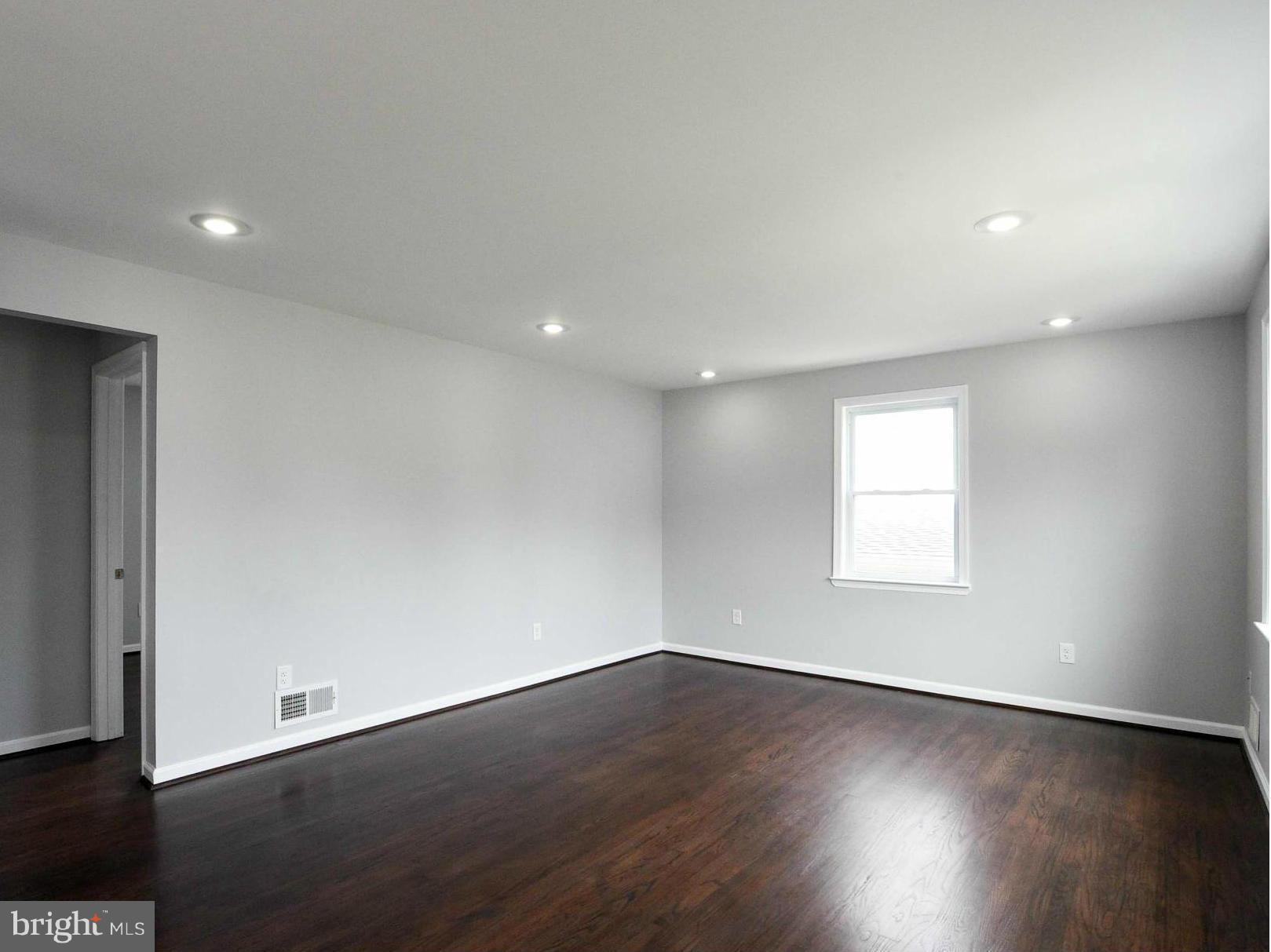 3822 Byfield Road Baltimore, MD 21207 - Photo 8 of 30 an empty room with wooden floor and window