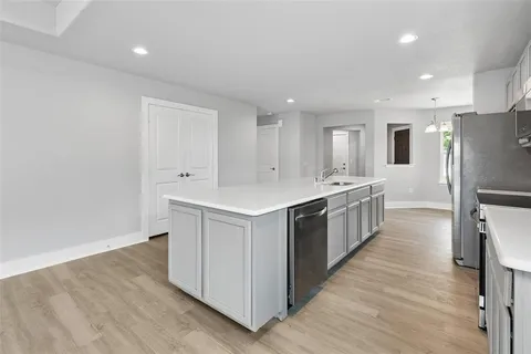 a kitchen with stainless steel appliances granite countertop a sink and cabinets