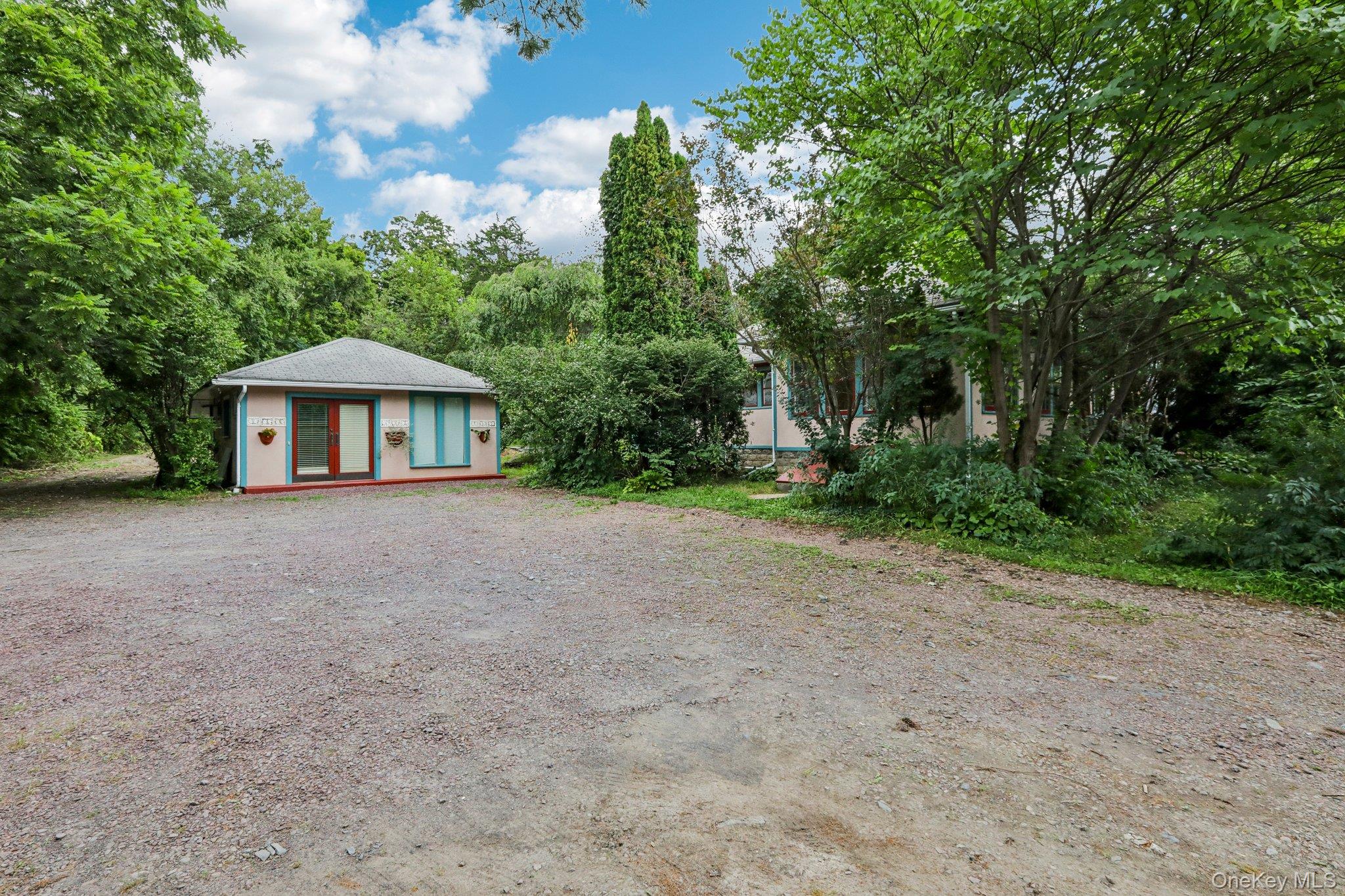 a front view of a house with a yard and trees
