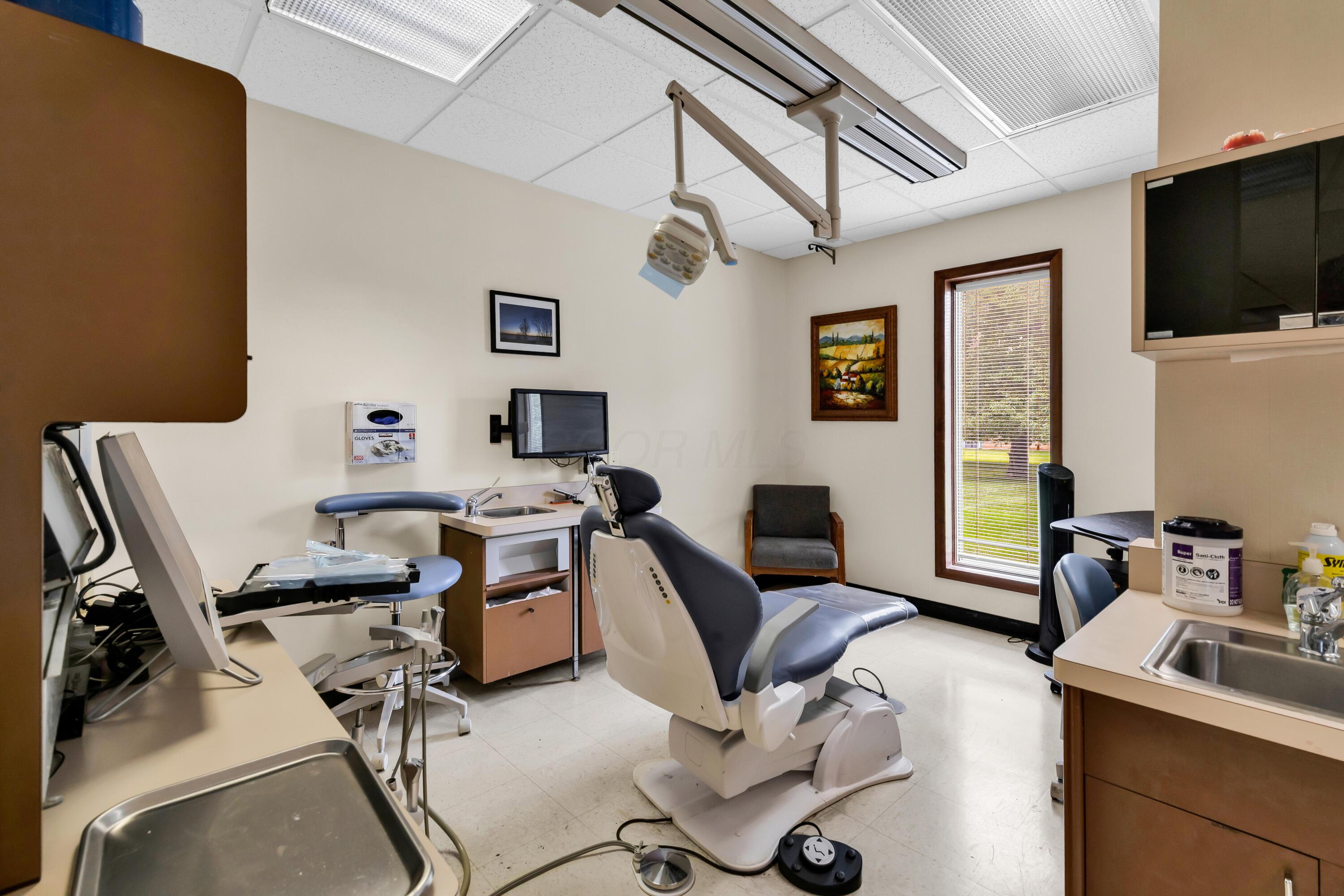 1240 Crescent Heights Road Marion, OH 43302 - Photo 36 of 60 • Neutral vinyl flooring • Ivory painted walls • Acoustic ceiling tiles • Fluorescent lighting • Enclosed vanity with single bowl, stainles steel sinktop • Divider • Lighting & equipment do not remain • Plumbed for oxygen & nitrogen
