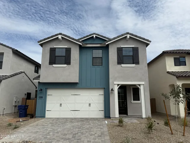 a view of a house with a yard and garage