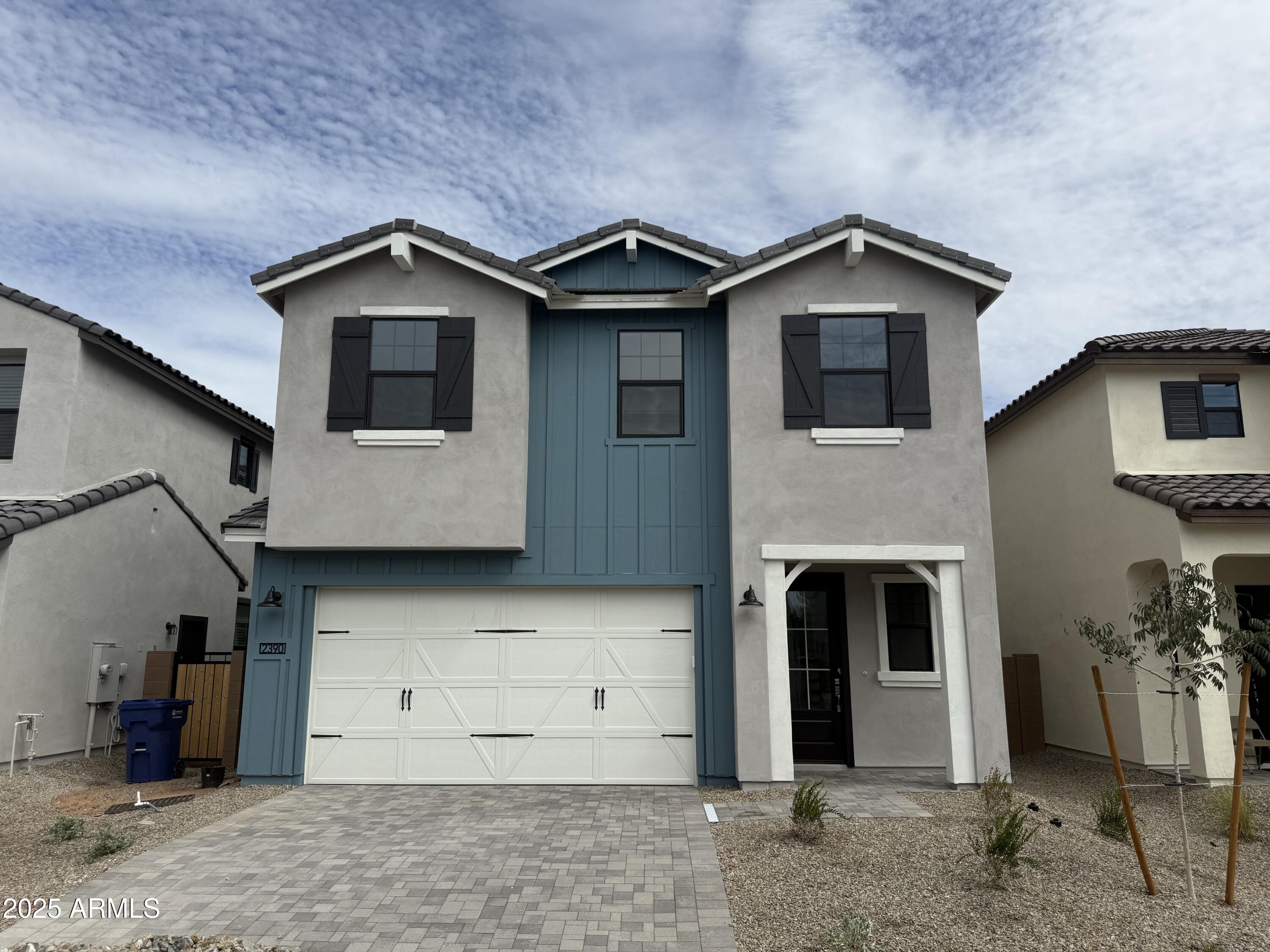 a view of a house with a yard and garage
