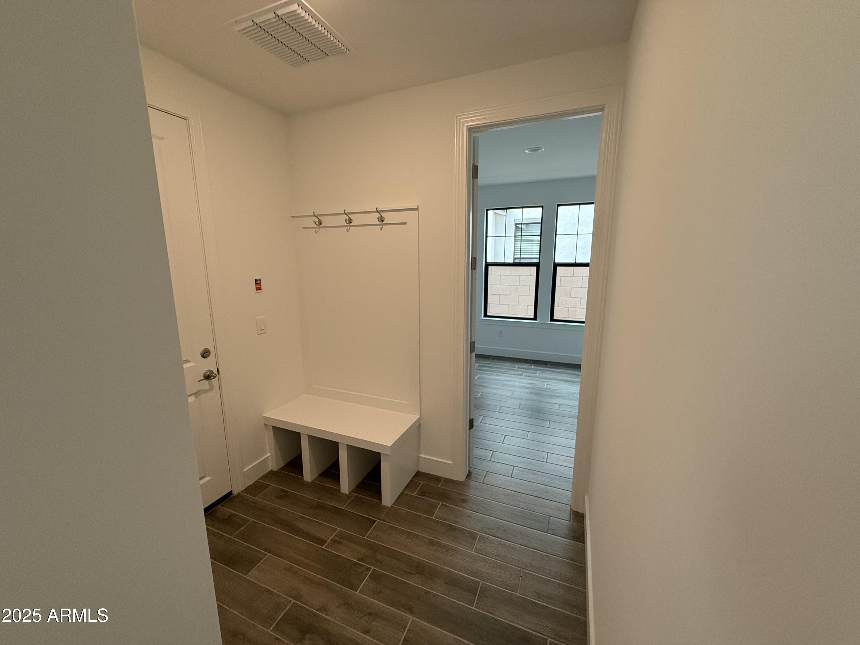2390 West Los Arboles Place Chandler, AZ 85224 - Photo 11 of 41 a view of a hallway with wooden floor and a cabinet