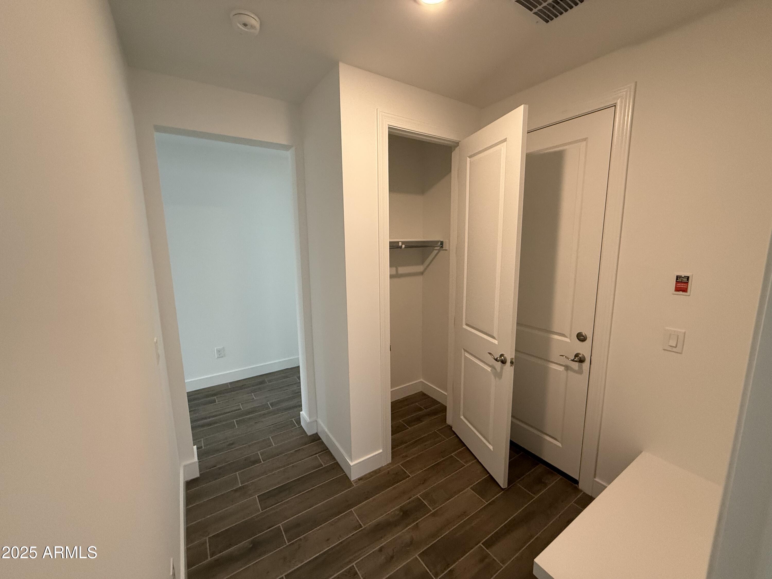 2390 West Los Arboles Place Chandler, AZ 85224 - Photo 12 of 41 a view of a hallway with wooden floor and closet area