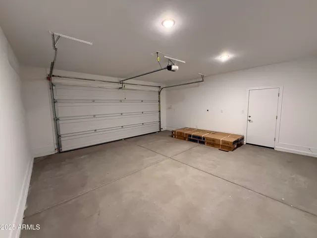a view of a hallway with wooden floor and a cabinet