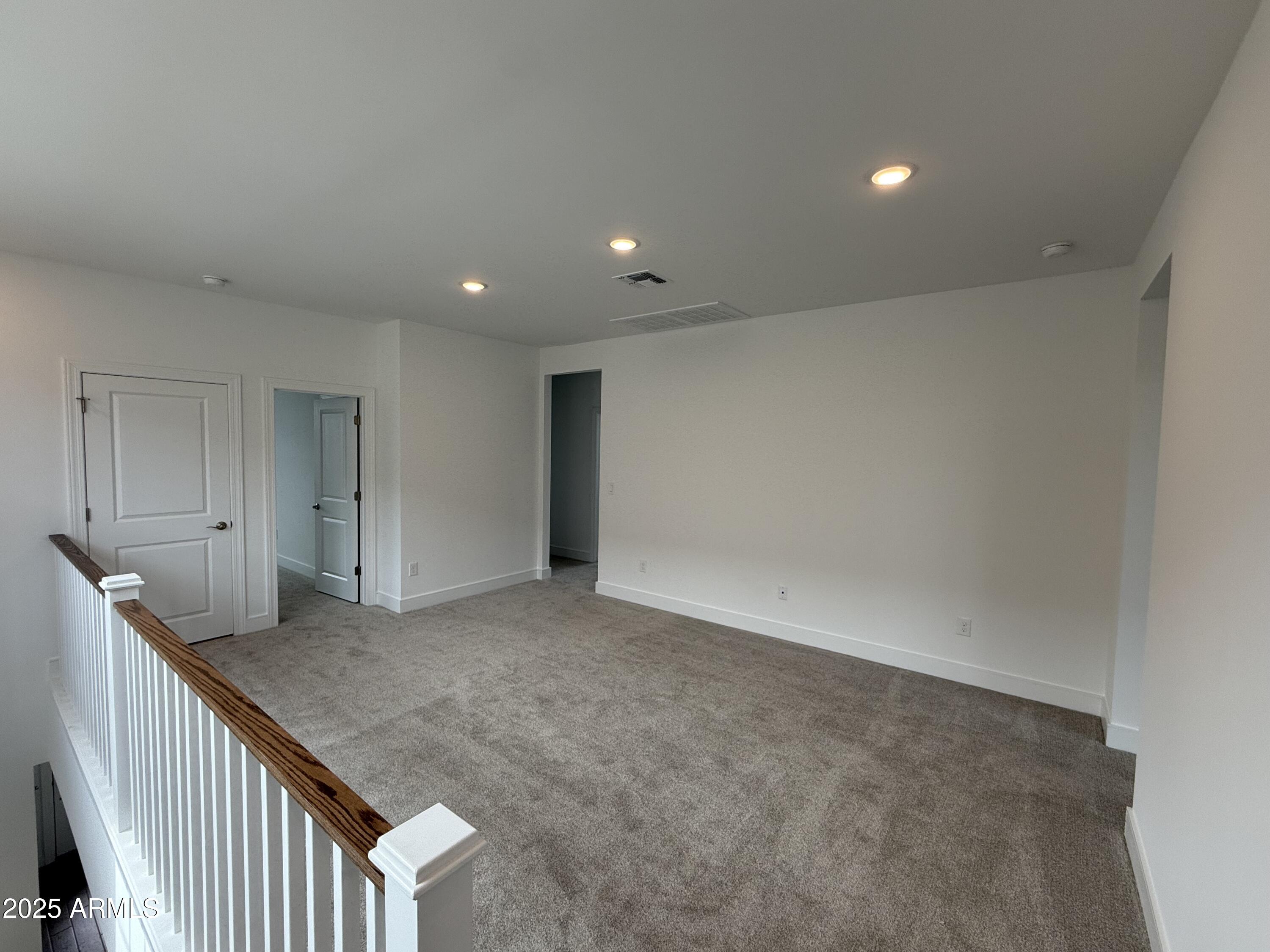 2390 West Los Arboles Place Chandler, AZ 85224 - Photo 17 of 41 a view of an empty room with wooden floor