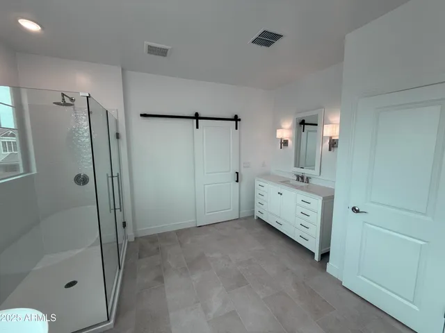 a bathroom with a double vanity sink a toilet a mirror and window