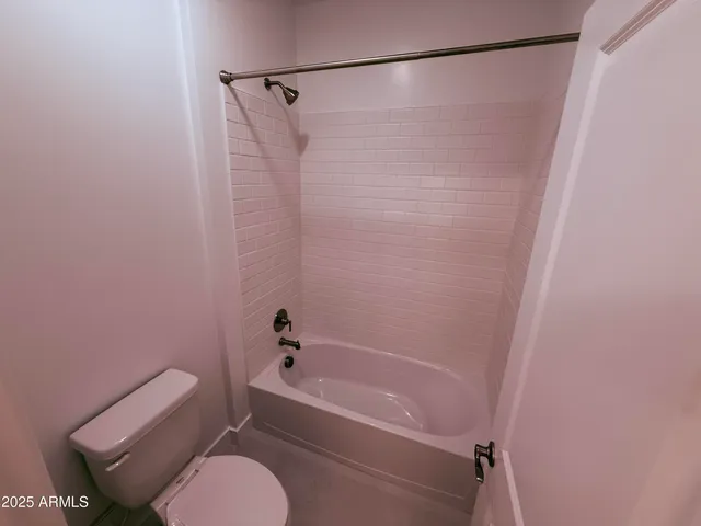 a bathroom with a toilet and a bathtub
