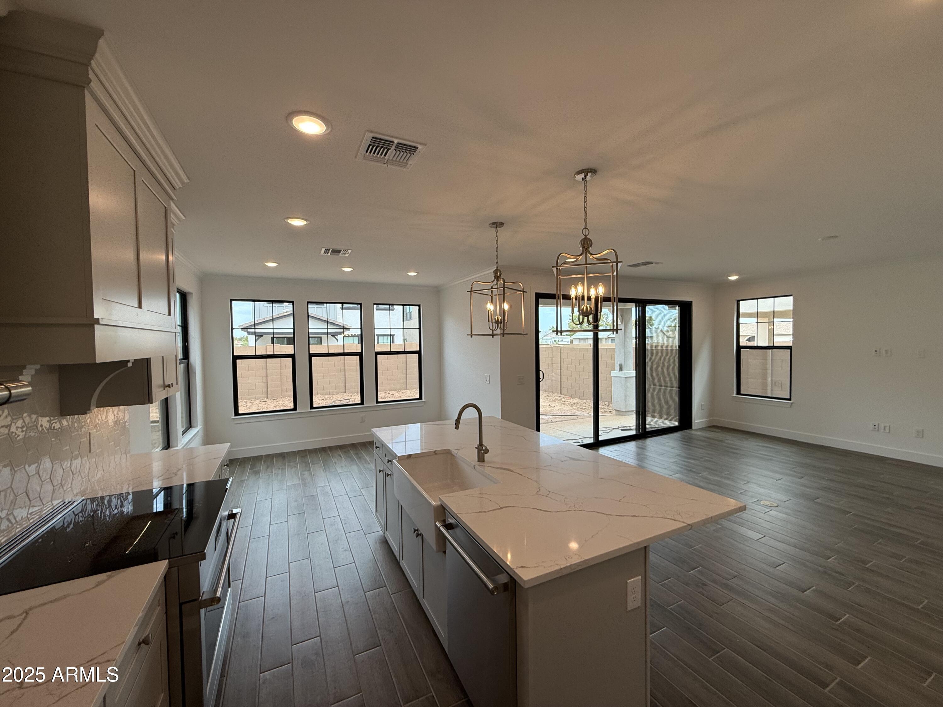 2390 West Los Arboles Place Chandler, AZ 85224 - Photo 4 of 41 a view of a kitchen with a sink and wooden floor