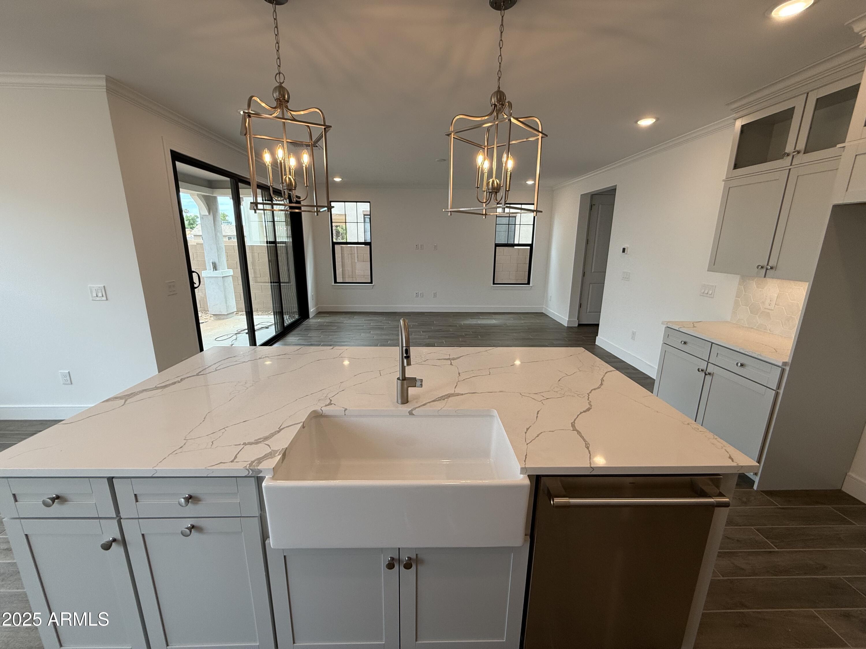 2390 West Los Arboles Place Chandler, AZ 85224 - Photo 5 of 41 a view of a kitchen island a sink stainless steel appliances and cabinets