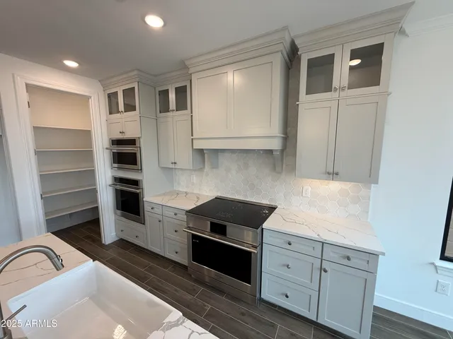 a view of a kitchen with a sink and wooden floor