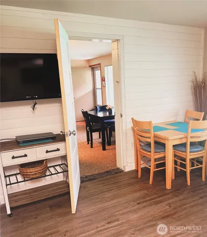 a view of a livingroom with furniture wooden floor and staircase