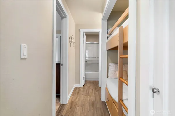 a view of a hallway with wooden floor and staircase