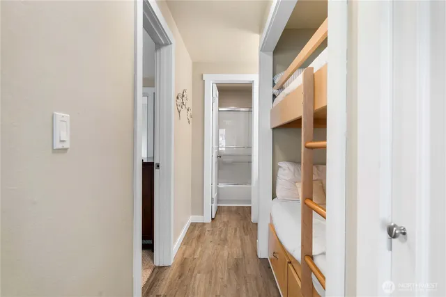 a view of a hallway with wooden floor and staircase