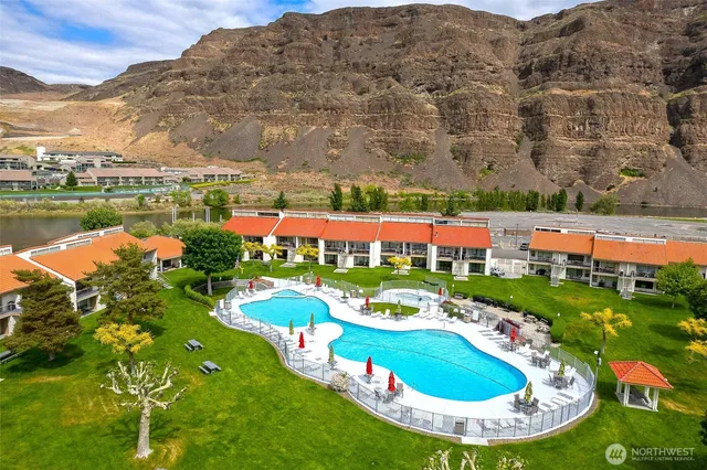 an aerial view of a house with outdoor space lake view and mountain view
