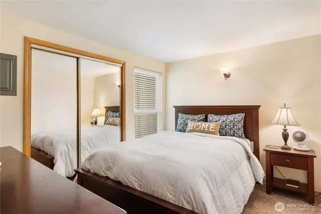 a bedroom with a bed and a night stand