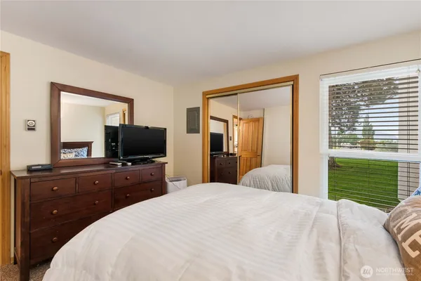 a bedroom with a bed and a flat screen tv