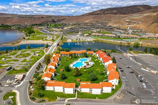an aerial view of residential houses with outdoor space and swimming pool