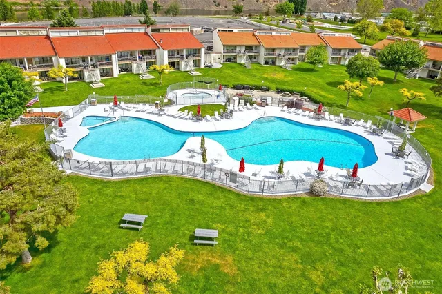 a view of an house with swimming pool garden and outdoor seating