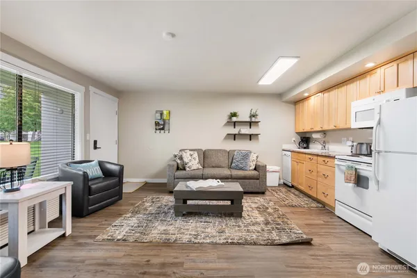 a living room with kitchen island furniture and a kitchen view