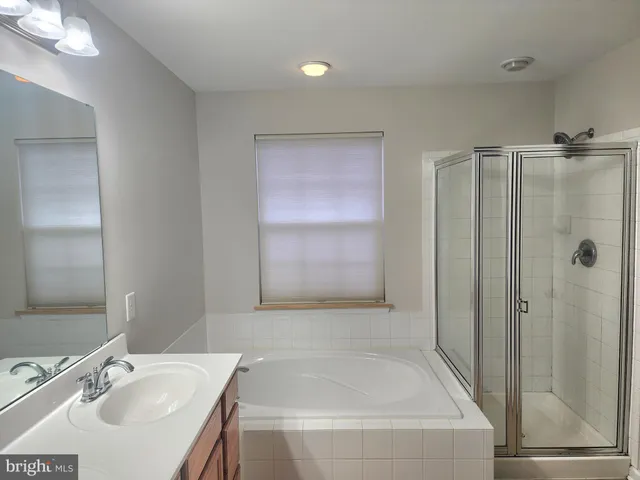 a bathroom with a sink a toilet a mirror and vanity