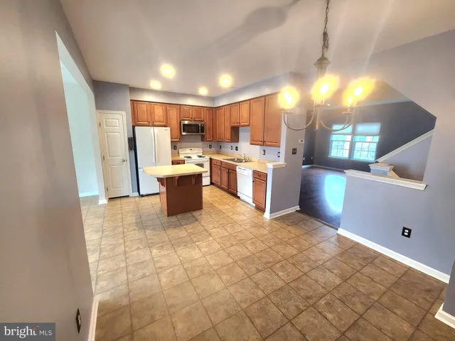 a kitchen with stainless steel appliances a refrigerator and a stove top oven