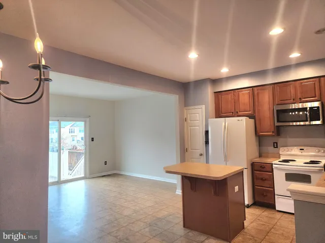 a kitchen with stainless steel appliances granite countertop a sink counter space and a window