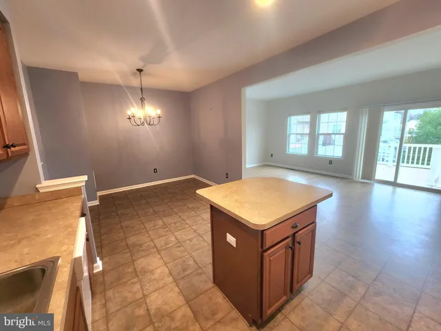 a view of an empty room with a chandelier