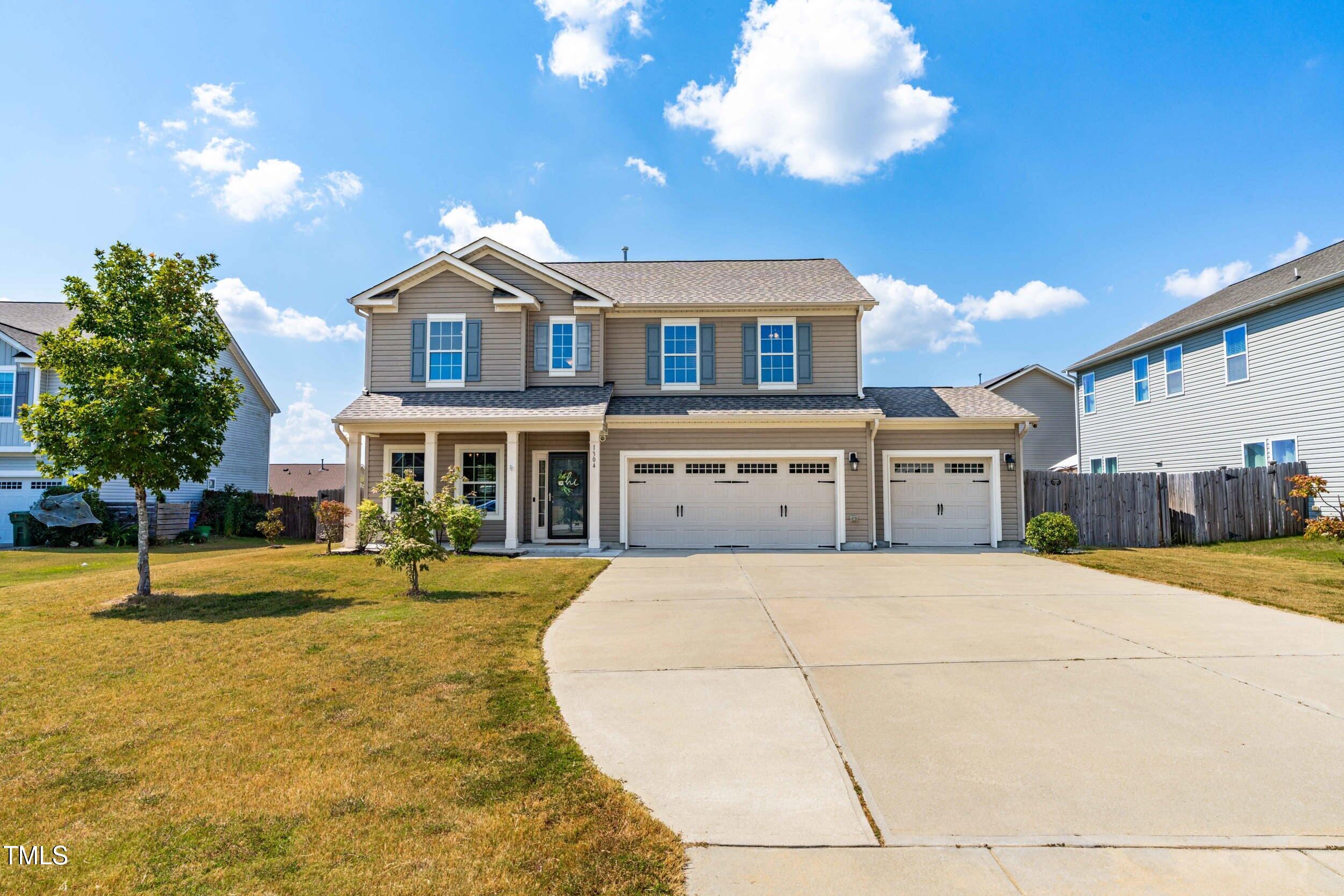 a front view of a building with a garden