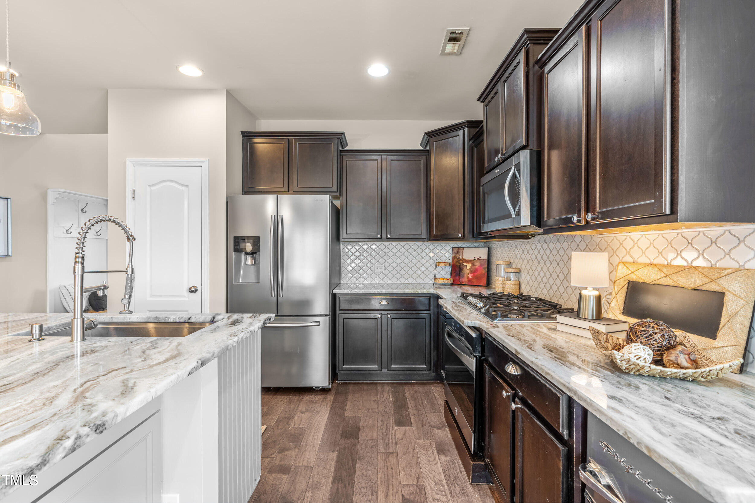 1304 Ivey Grove Court Fuquay-Varina, NC 27526 - Photo 12 of 44 a kitchen with a sink stove and refrigerator